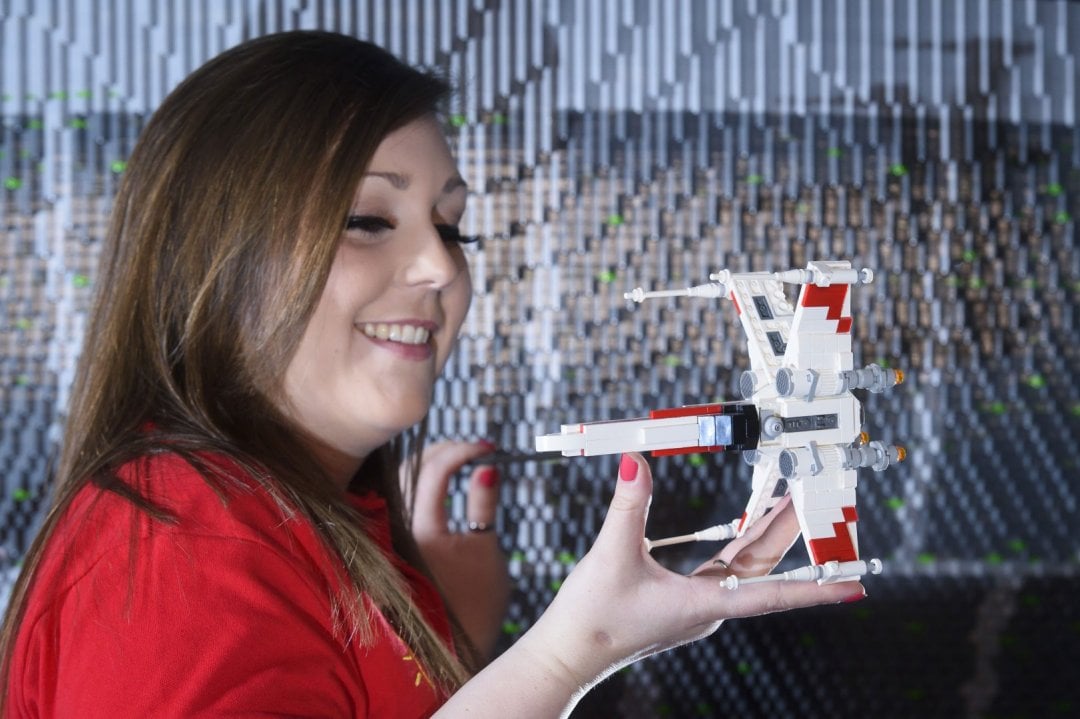 ONE OF THE WORLD’S BIGGEST EVER LEGO® STAR WARS™ MODELS INSTALLED AT THE LEGOLAND® WINDSOR RESORT. LAST PIECES PUT IN PLACE IN NEW LEGO® Star Wars™ Miniland Model Display Finale.  LEGOLAND® Model Maker Phoebe Rumbol, puts the finishing touches to some of the Rebel Alliance ships featured in a new finale scene to the Resort’s LEGO® Star Wars™ Miniland Model Display. This is one of the smaller elements to the 651,086 brick scene and the centre piece is one of the most impressive and biggest LEGO® Star Wars™ models ever created - a 500,000 brick LEGO® Star Wars™ recreation of The Death Star.   The models were installed in a mammoth operation that took three days as the massive new 2.4 metre wide, 3 metre high creation was carefully hoisted into position and the final bricks and scenes were put in place. The hefty 860kg perfectly spherical model took 15 Model Makers three months to build and guests can trigger special effects and bring the scene to life when it opens at the Resort on 11 March.